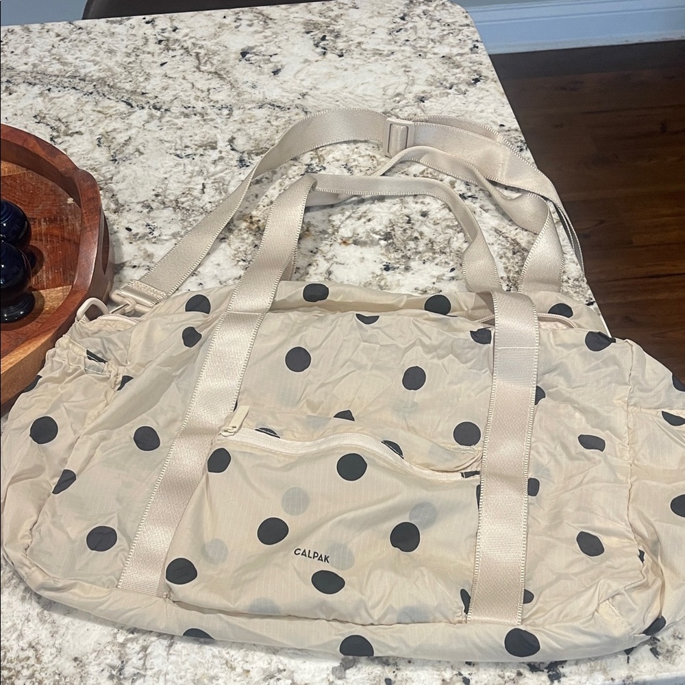 Calpak Cream Travel Duffel with Black Polka Dots